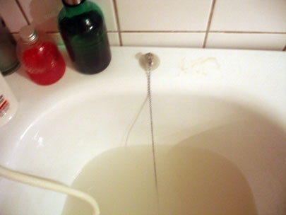 and the tap drips under the strip light